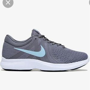 Nike women Revolution 4 sneakers. Size 8.5. Grey with a blue swoosh. Like new.